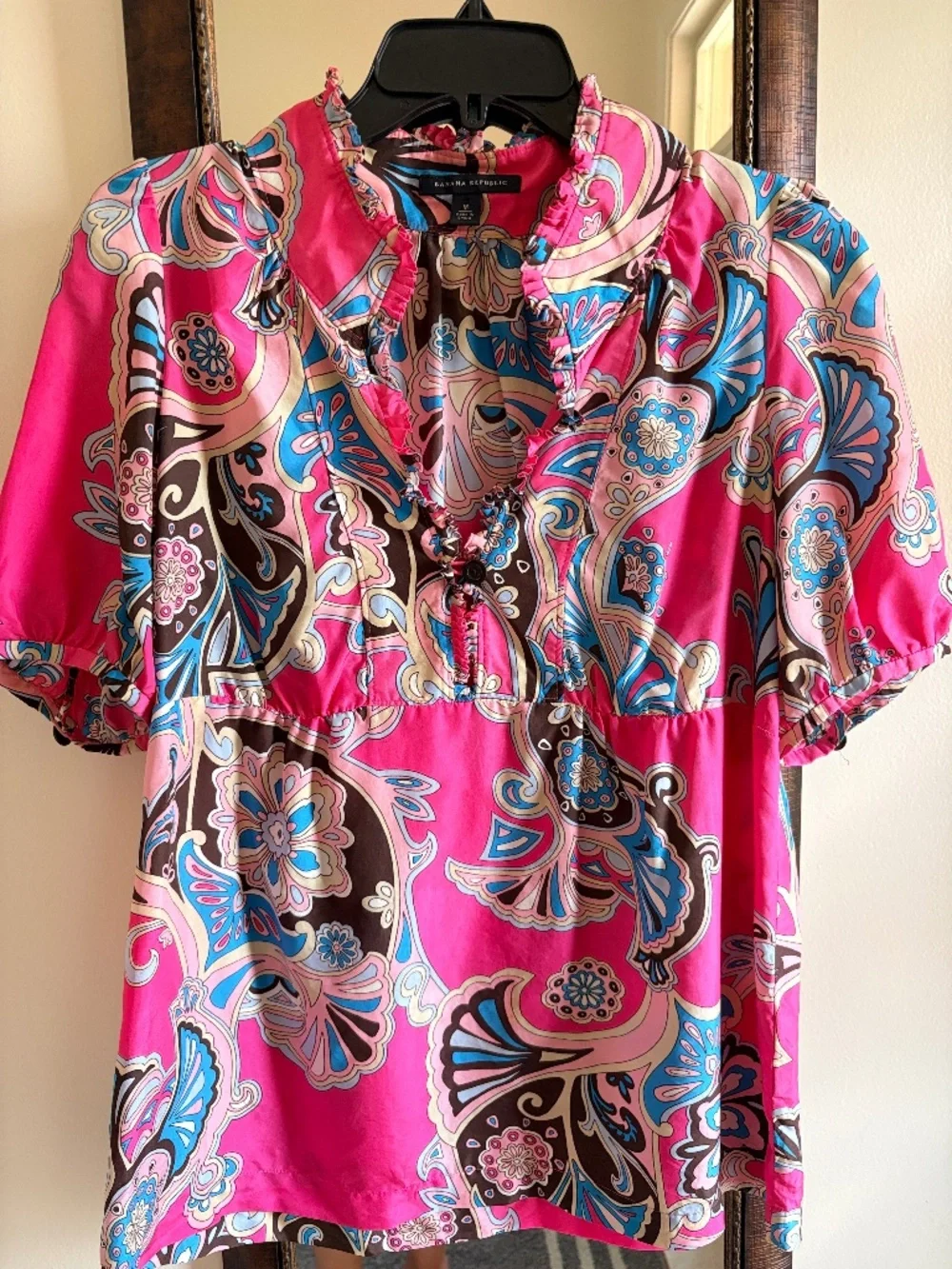 100% Silk ruffle-neck blouse.